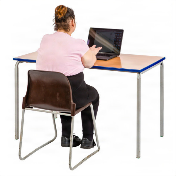 Woman sitting at a desk on a laptop.
