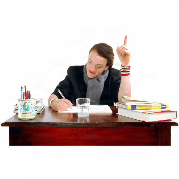 Person writing at a desk with books, a mug of pens, and a glass of water.