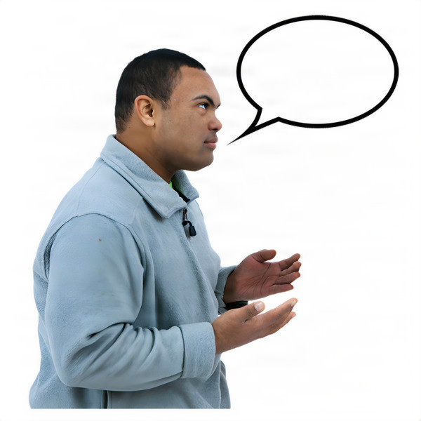 A man in a grey pullover with a speech bubble above his head, gesturing with his hands.