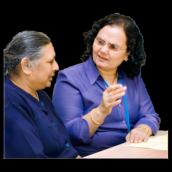 Two women having a conversation at a table.