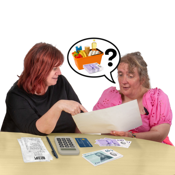 Two women discussing finances with a calculator and money on the table.