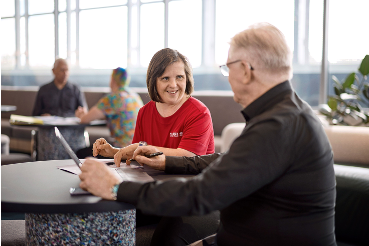 A support worker helping a student