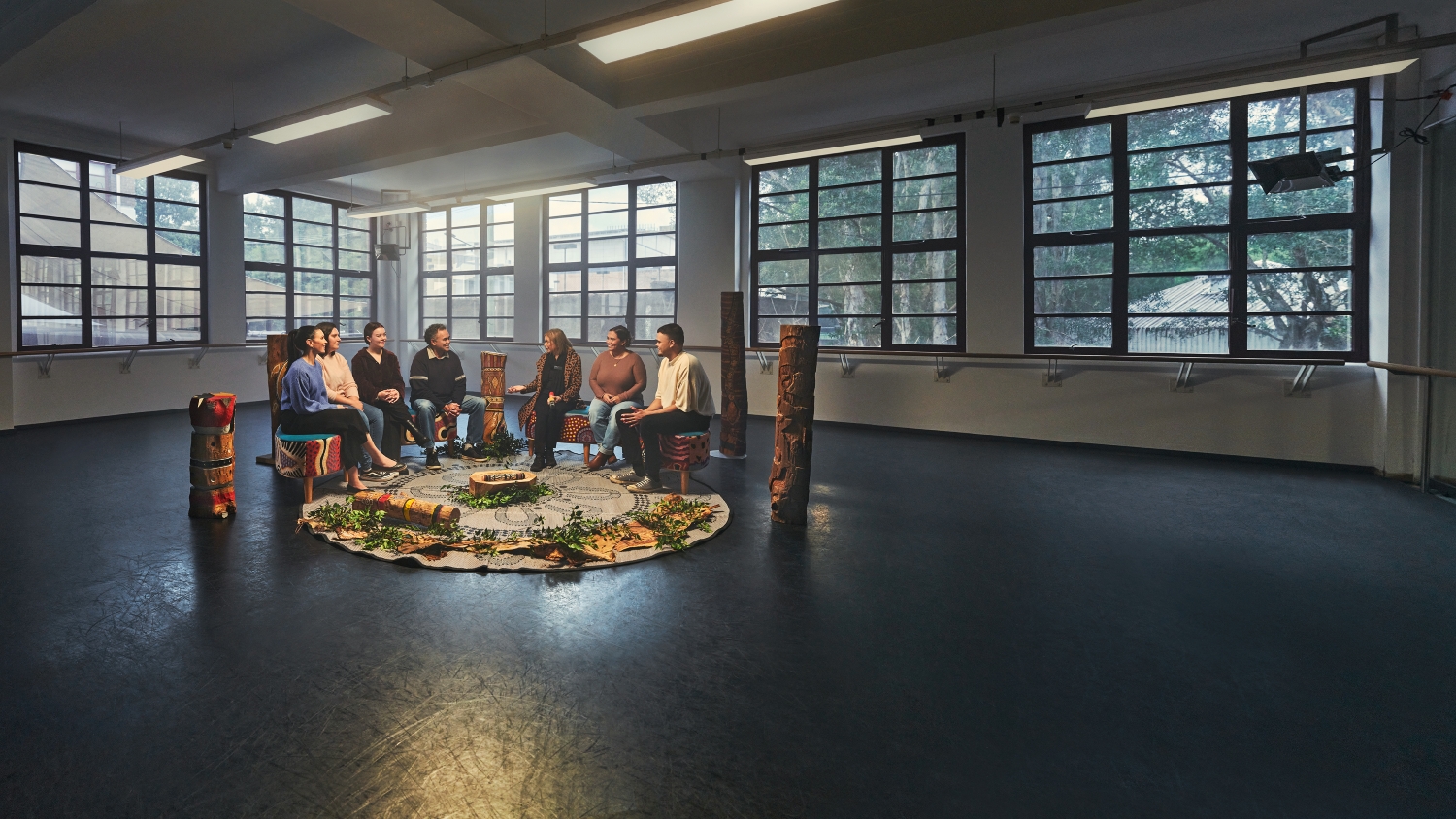 People sitting together in a yarning circle and talking.