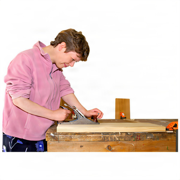 Person woodworking at a bench with tools.