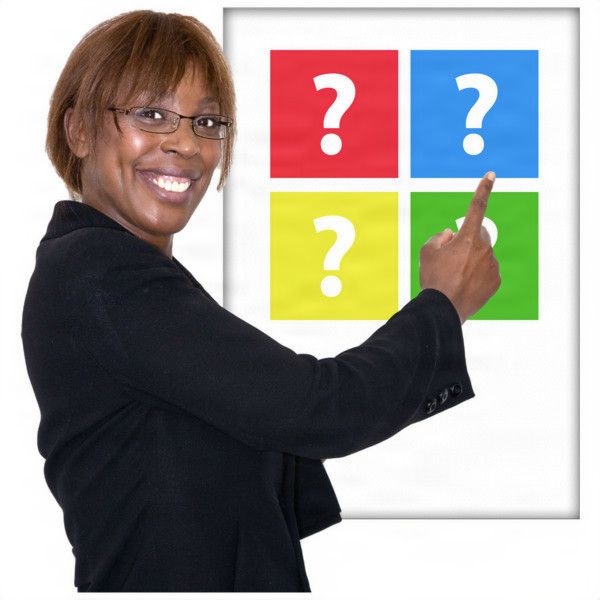 Woman in a black blazer pointing at a colourful chart with question marks.