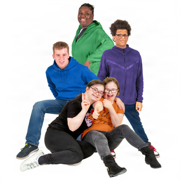 Five young people smiling and posing together in casual clothing.