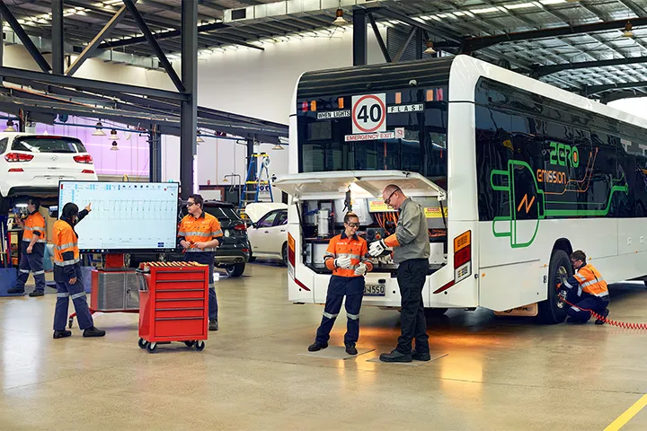 Mechanics in a workshop working on an electric bus