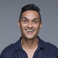 Biripi man, Andrew Saunders, wearing a navy collared shirt, looking front on with a big smile on his face.