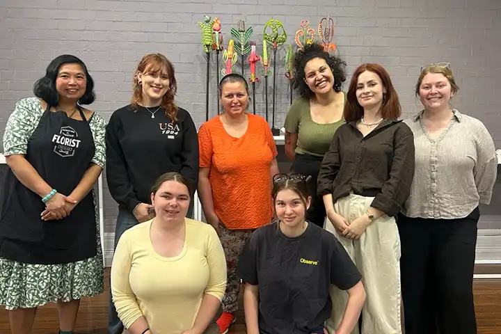 Certificate IV Arts and Cultural Administration students gather in the Muse Gallery, featuring artwork in the background.