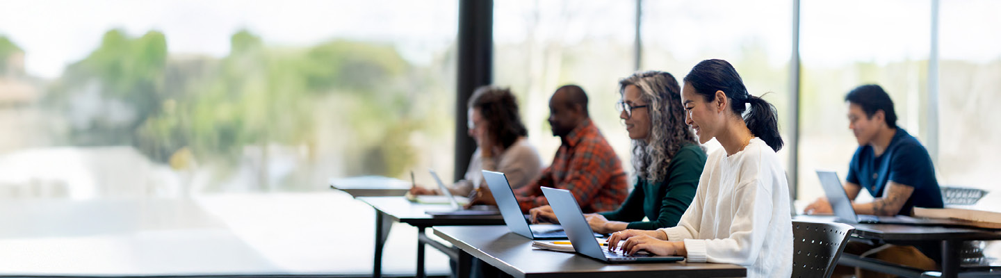 Group of learners using laptops for educational purposes