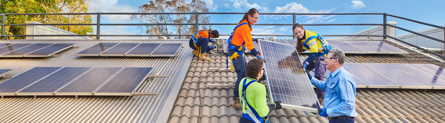 Professionals installing solar panels for renewable energy